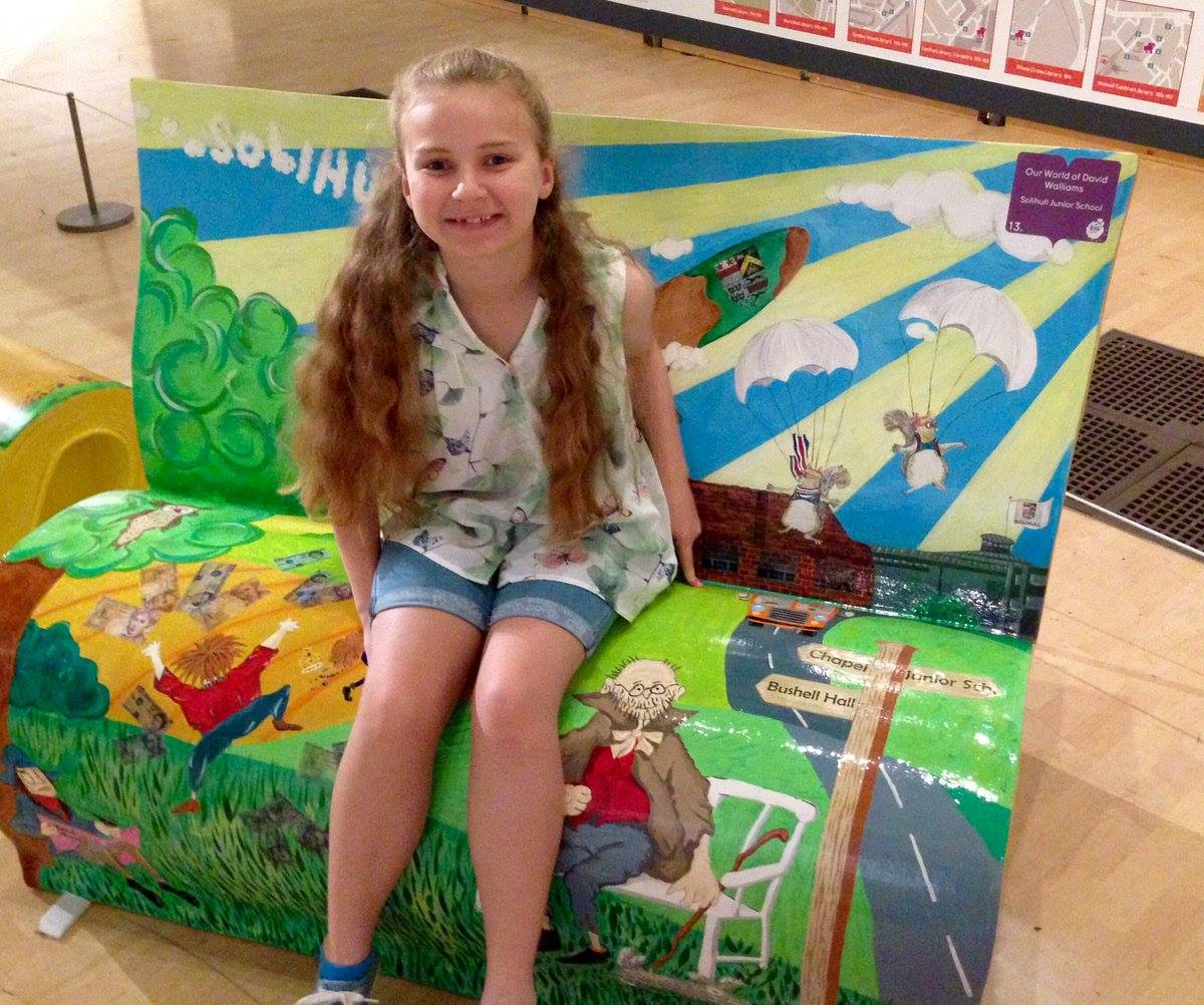 Junior School pupil sitting on BookBench